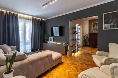 a living room with a couch and a tv at Grand Suborna Retreat in Sofia