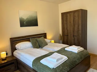 a bedroom with a bed with towels on it at Apart-Tundzha 6 in Sofia