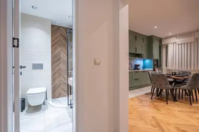 a kitchen and dining room with a table and chairs at Elegant & Stylish 2-Bedroom Apartment in Sofia