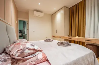 a bedroom with a bed and a large mirror at Elegant & Stylish 2-Bedroom Apartment in Sofia