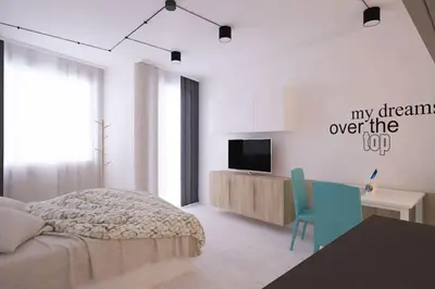 a bedroom with a bed and a desk and a tv at Natan Royal in Sofia