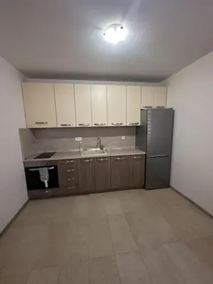 an empty kitchen with a refrigerator and a sink at The Last Dollar in Sofia