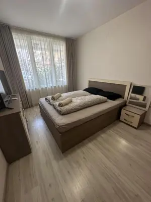a bedroom with a large bed and a window at The Last Dollar in Sofia