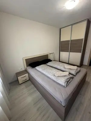 a bedroom with a large bed with a wooden floor at The Last Dollar in Sofia