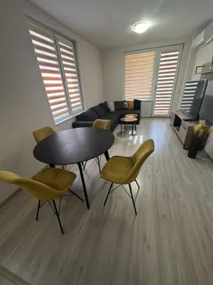 a living room with a table and chairs and a couch at The Last Dollar in Sofia