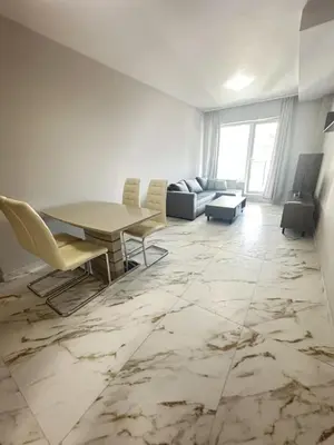 a living room with a table and chairs and a couch at No Remorse Tower & private parking in Sofia