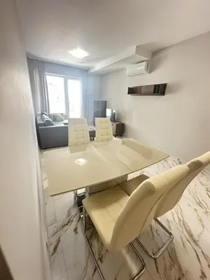 a dining table and chairs in a living room at No Remorse Tower & private parking in Sofia