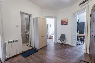 an empty room with a door and a chair in it at Vitoshka Inn - R1 in Sofia