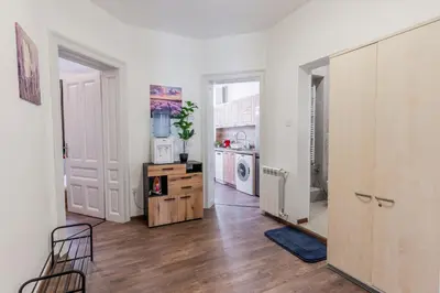 a kitchen with white walls and a wooden floor at Vitoshka Inn - R1 in Sofia