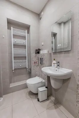 a white bathroom with a sink and a toilet at Vitoshka Inn - R1 in Sofia