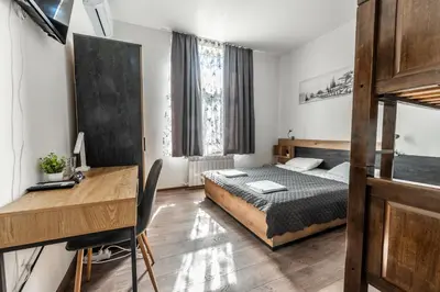 a bedroom with a bed and a desk in it at Vitoshka Inn - R2 in Sofia