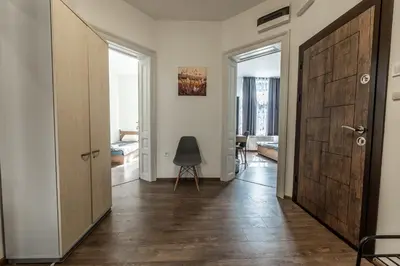 a hallway with a door and a chair in a room at Vitoshka Inn - R2 in Sofia