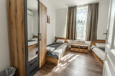 a small room with two beds and a mirror at Vitoshka Inn - R3 in Sofia