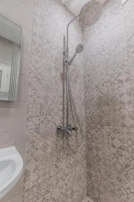 a shower stall in a bathroom with a sink at Vitoshka Inn - R3 in Sofia
