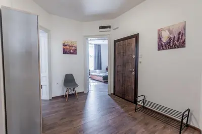 a hallway with a door and a chair in a room at Vitoshka Inn - R3 in Sofia