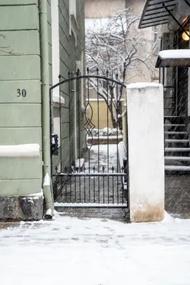 a iron gate in front of a building with snow at Vitoshka Inn - R3 in Sofia