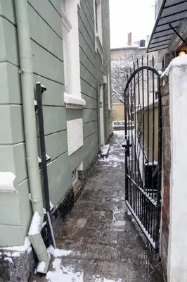 an alley with snow on the side of a building at Vitoshka Inn - R3 in Sofia