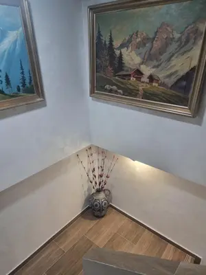a room with two paintings on the wall and a vase at Vila Nikol Apt #3 in Raduil