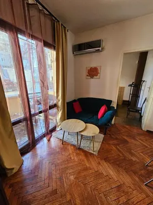 a living room with a couch and a table at Hot Spot 2bdrm apartment 1 in Sofia