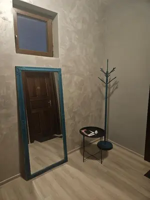 a mirror and a stool in a room with a door at Hot Spot 2bdrm apartment 1 in Sofia