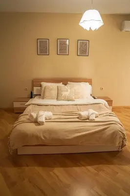 a bedroom with a large bed with towels on it at Azuri in Sandanski