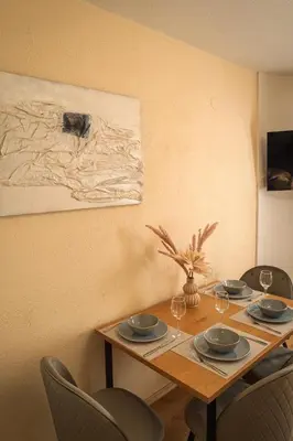 a dining room table with chairs and a painting at Azuri in Sandanski