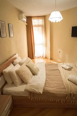 a large bed in a room with a window at Azuri in Sandanski