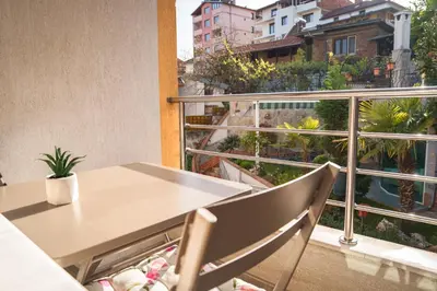a table and chair on a balcony with a view at Azuri in Sandanski