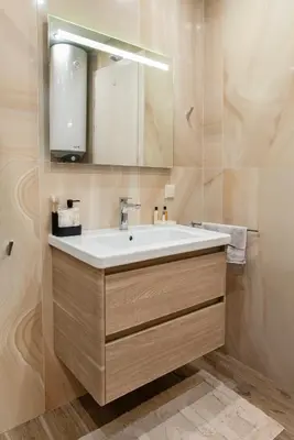 a bathroom with a sink and a mirror at Luxury Stays Kapana Plovdiv in Plovdiv