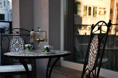 a small table and chairs on a balcony at Luxury Stays Kapana Plovdiv in Plovdiv