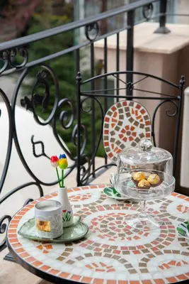 a table with a tray of food on a balcony at Luxury Stays Kapana Plovdiv in Plovdiv