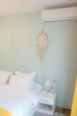 a bedroom with a white bed and a lamp at Claire Apartment with Garden in Sofia