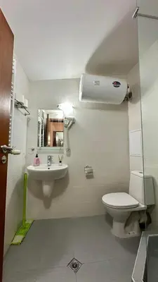 a bathroom with a sink and a toilet and a mirror at Belvedere Holiday Club Apartment 503 in Bansko