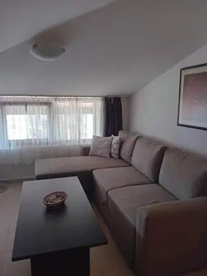 a living room with a couch and a table at Belvedere Holiday Club Apartment 503 in Bansko