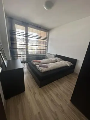 a bedroom with a bed and a large window at Luxury Cult & private parking in Sofia