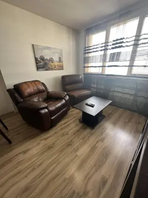 a living room with a leather chair and a coffee table at Luxury Cult & private parking in Sofia