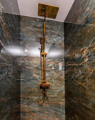 a shower in a bathroom with a black marble wall at АРТ Къща Широка Лъка in Shiroka Lŭka
