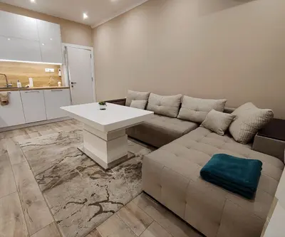 a living room with a couch and a table at Дрийм in Plovdiv