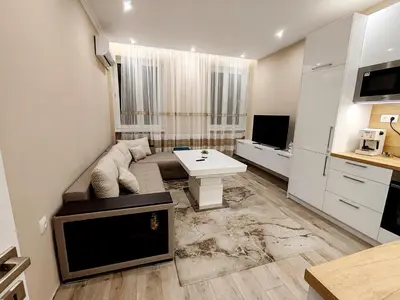 a small living room with a couch and a table at Дрийм in Plovdiv