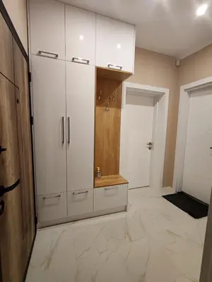 a bathroom with white cabinets and a tiled floor at Дрийм in Plovdiv
