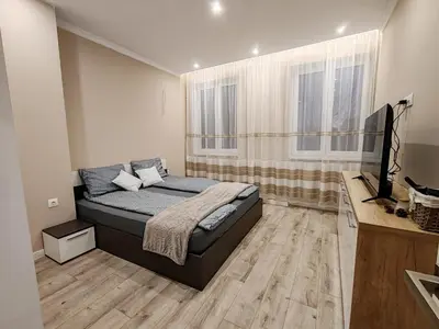 a bedroom with a bed and a television in it at Дрийм in Plovdiv