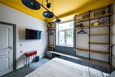 a bedroom with a yellow ceiling and a bed and a window at 5 Vintage Guest House in Sofia