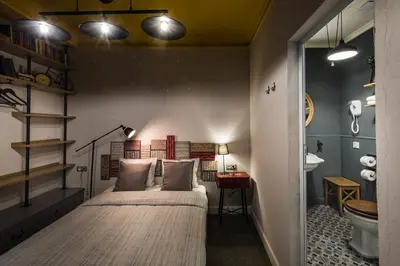 a bedroom with two beds and a bathroom at 5 Vintage Guest House in Sofia