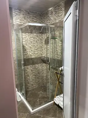 a shower with a glass door in a bathroom at SUGARFAME- Guest House in Sarnitsa