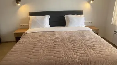 a bedroom with a large bed with two pillows at SUGARFAME- Guest House in Sarnitsa