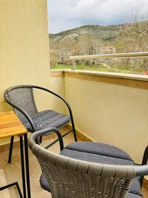 a couple of chairs and a table on a balcony at Luxury Park Villa in Sandanski