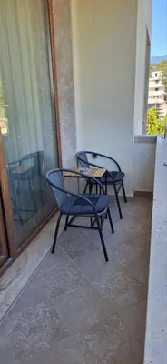 two chairs and a table on a balcony at Luxury Park Villa in Sandanski