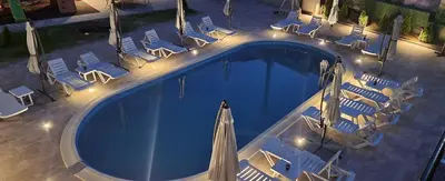 an overhead view of a swimming pool with chairs and an umbrella at Къща за гости Стефани in Devin