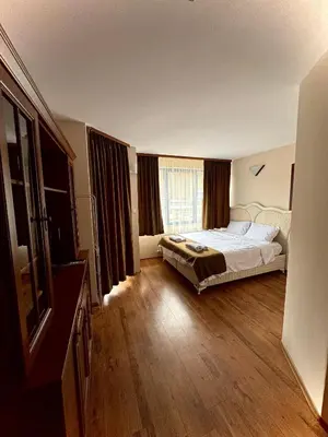 a bedroom with a bed and a large window at Къща за гости Стефани in Devin