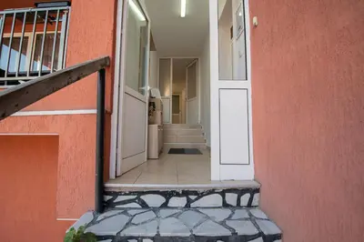 a hallway of a house with a door and stairs at Hyggemate - 1 Bed Room Cozy Apartment in Sarnitsa in Sarnitsa